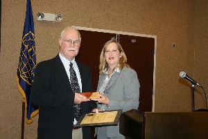 In August, Jackie Whittaker, chapter president, presents a plaque to the chapter's newest Life Member, Thomas Batty.
