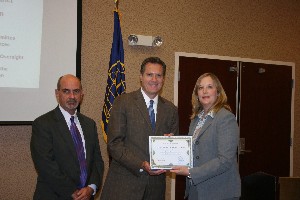 In August, Rep. Michael R. Turner (c), (R-OH), 3rd Congressional District, receives a plaque from Jackie Whittaker, chapter president, and Dan Curtis, chapter vice president for programs.