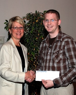 Kathy DeMolet, vice president, chapter education, presents Senior Airman Matt Janson, USAF, Springfield Air National Guard, with the Milton E. Cooper/Young AFCEAN Technical Certification Scholarship at the June meeting.
