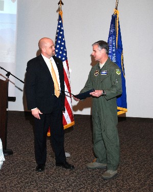 Brig. Gen. Walter D. Givhan, USAF (r), commandant, Air Force Institute of Technology, Wright-Patterson Air Force Base, Ohio, receives a certificate of appreciation from David Hart, chapter president, for speaking at the January meeting.
