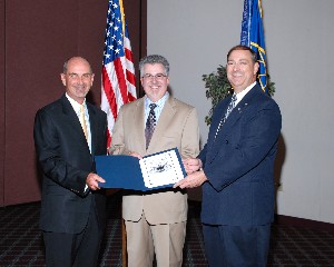 At the May luncheon, Dan Curtis (l), chapter vice president for programs, and Norman Nelson (r), chapter executive vice president, thank guest speaker Randy Adkins, director of Air Force Knowledge Now.