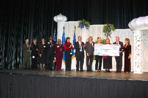 Chapter President Dennis Doucet (2 from r) presents Chapter Vice President of Education Kathy DeMolet with a check for $50,000 at the 2006 AFCEA Infotech Banquet for the Chapter's Scholarship Fund from the proceeds of the conference. Also pictured are members of local colleges and universities who will be receiving financial support from the Chapter.
