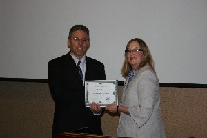 Jackie Whittaker (r), chapter president, presents Jeff E. Graham, senior technical adviser, Computational Science and Engineering Office, Headquarters, Air Force Research Laboratory, with a certificate of appreciation following his speech at the May meeting.