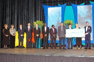 Chapter members and university recipients of scholarship funds gather onstage at the October InfoTech event's black tie banquet in recognition of outstanding achievement and academic merit.