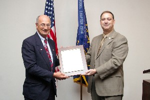 Norman Nelson, vice president of corporate membership, presents longtime member Anthony Perfilio of Rendigs, Fry, Kiely & Dennis, LLP with a new corporate member plaque.