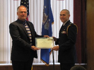 In May, Cadet Jonathan Harris (r), Wright State University, chapter Honor Certificate Award winner, receives his award from Fauch.

