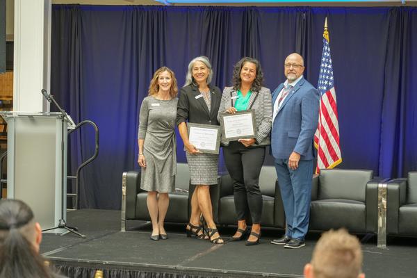 In September, Tina Jordan, vice president of membership, AFCEA International (far l), and David Hart, regional director, Mid-West Region (far r), present Certificates of Appreciation to Teresa Macalolooy, the chapter's Wright Innovative Technology Summit (WITS) program chair (second from l), and Krystin Fakalata, chapter president.