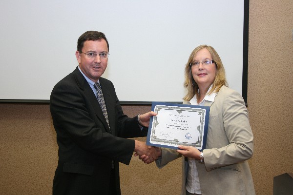 Dr. Steven Butler, executive director, Air Force Materiel Command, receives a chapter certificate from Jackie Whittaker, chapter president, in July.
