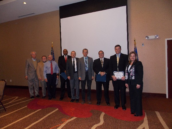 Rick Wegmann (l), board president, and Linda Skinner (r), chapter president, recognize panelists with certificates following the November forum.