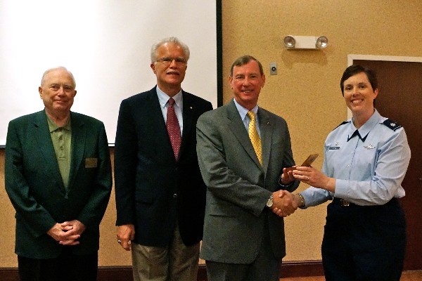 Lt. Col. Brenda Oppel, USAF, chapter vice president, programs, presents Brown with the chapter coin in July. Also pictured (l-r) are Fred Scheyd, regional vice president. and Rick Wegmann, chapter board president.