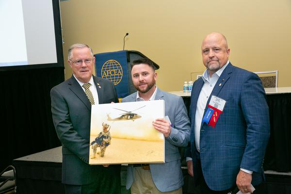 Gen. Shea poses for a photo with Sgt. Wallace and Sgt. Hart at the TechNet Cyber Conference in May.