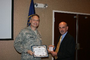 In November, Gen. Haywood (l) receives a coin and certificate from the Daniel Curtis, chapter vice president for programs.