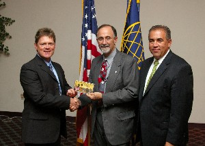 Gerald Tritle (l), chapter president, presents September guest speaker Joe Sciabica (c), U.S. Air Force Research Labratory, with a Wright brothers coin set as a token of appreciation, while Michael Bridges, chapter programs vice president, looks on.