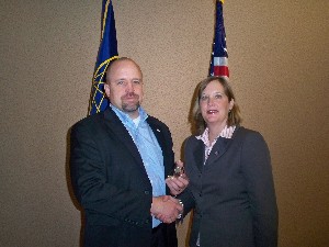 At the January luncheon, Whittaker (r) presents David Hart, outgoing chapter president, with a gift of appreciation.