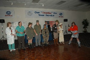 At the August M*A*S*H Bash, winners of the costume contest collect their cash prizes. 