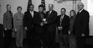 Mr. Doucet is presented with a commemorative Wright Flyer coin by the chapter vice presidents for his service to the chapter for 2006. 