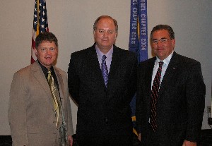 Tritle (l) and Michael Bridges, chapter programs vice president (r), thank guest speaker Thomas W. Krusemark with a Wright Brothers Coin set as a token of appreciation.