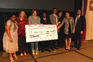 In October, the chapter unveils a scholarship fund check for $30,000.