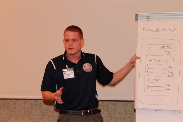 Airman 1st Class Matthew Smith, USAF, vice president for Young AFCEAN affairs, discusses an AFCEA app during the first European Young AFCEAN Conference in October in Berlin.