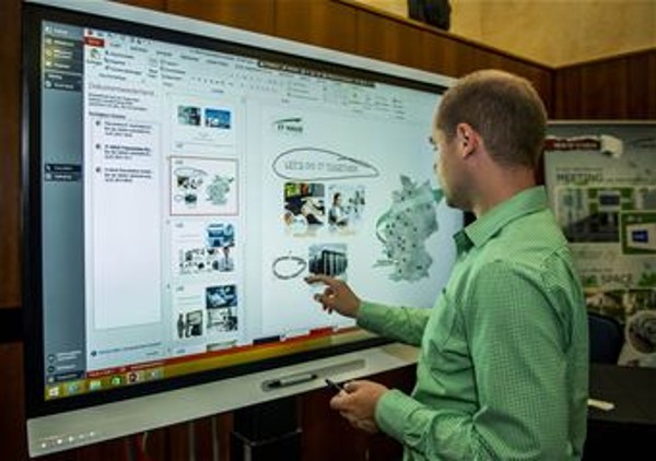 At July's Tech Expo in Germany, a technology industry representative showcases his company's product. 