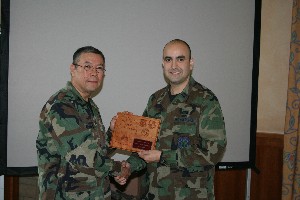 Capt. Thomas Avilucea (r), USAF, presents recognition plaque to Col. Thomas Brown, USAF, for his January guest presentation.