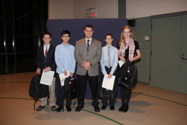 Chapter President Lt. Col. Matthew Imperial, USAF (c), presents (l-r)  Grayson Brobeck, Jae Kim, Logan Thursby and Camille Miles with special science, technology, engineering and mathematics (STEM) monetary awards.