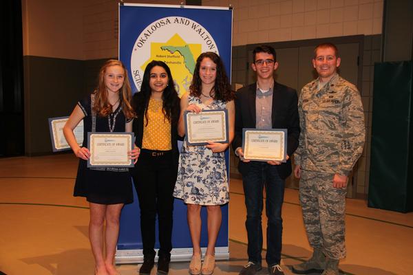 Maj. Preston Iverson, USAF, 53rd Computer Systems Squadron and chapter board member (r), honors chapter award winners (l-r) Emma Daldine, Simrun Sharma, Clara Beth Lafollette and Laim Ordner in February. Maj. Iverson was one of a group of chapter judges volunteering in the East Panhandle Regional Science and Engineering Fair in Fort Walton Beach, Florida.