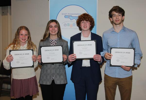 STEM science project winners (l-r) Elena Henderson, Aurora Mendenhall, Jackson Despard and Owen Parry, display their awards at the February East Panhandle Regional Science Fair in Fort Walton Beach, Florida.