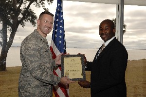 Lt. Col. Rob Lyman, USAF (l), chapter president, awards a lifetime membership certificate and pin to Robert Riley at the January meeting.