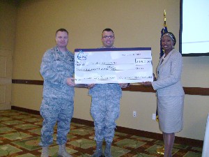 In October, Lt. Col. Keith Perkins, USAF (l), chapter president, and Glenda Stewart (r), chapter vice president for education and scholarships, present the CSC Technical Defense Scholarship to 2nd Lt. Andrew Lingenfelter, USAF, a student at the University of Florida.