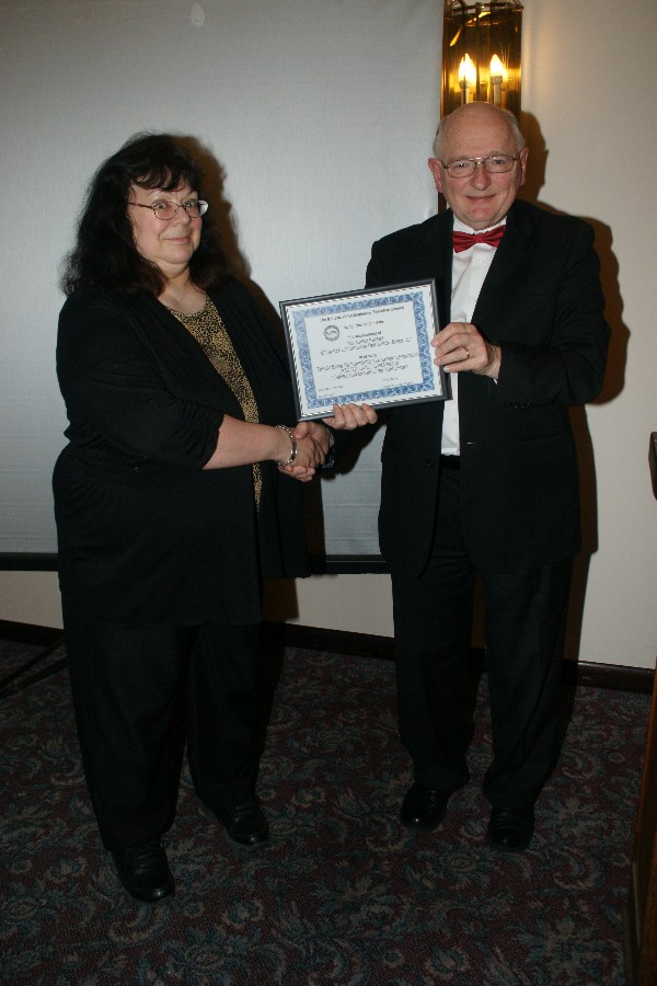Nancy Koziarz, chapter symposia chairman, receives the 2014 Professional of the Year Award from Eugene Blackburn, chapter board chairman, at the Mohawk Valley Engineers' Executive Council (MVEEC) 65th Annual Engineers Banquet in April.
