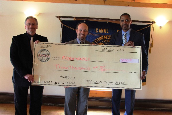Rick Lockridge, chapter president (r), presents a check to Project Fibonacci founder Andrew Drozd of ANDRO Computational Solutions (l) and Daniel Kostelec, ANDRO's science, technology, engineering, arts and mathematics (STEAM) outreach coordinator, in May.