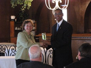 Janis M. Norelli, small business specialist, Information Directorate, Air Force Research Laboratory, Rome, New York, accepts a token of thanks from Rick Lockridge, chapter president, for her presentation at the March meeting.

