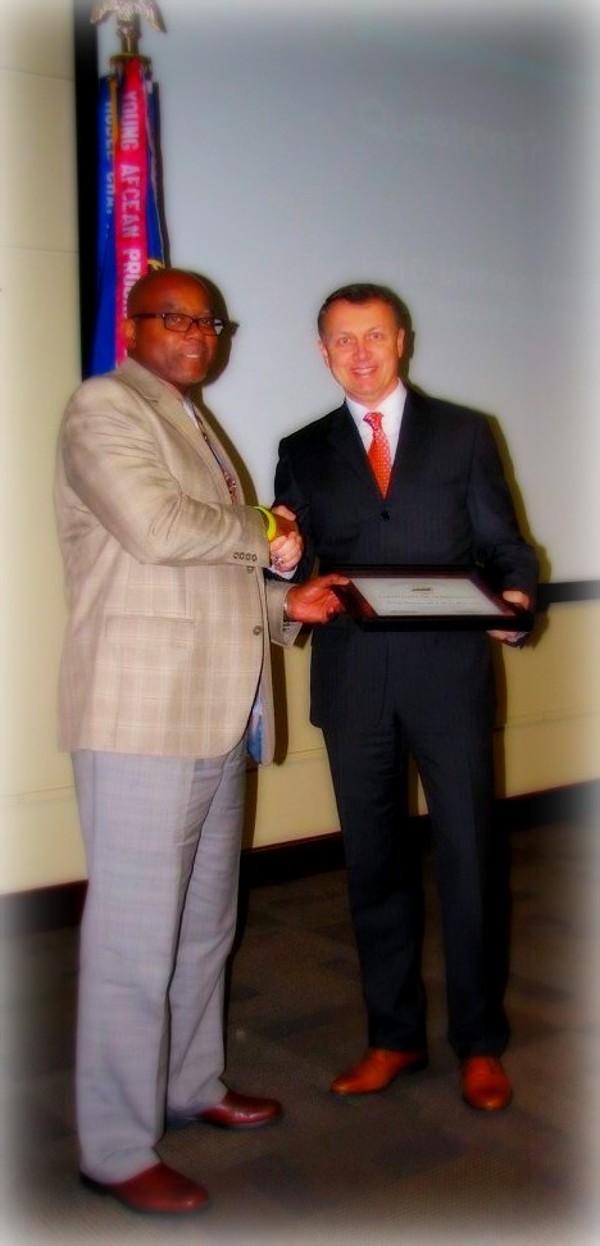 Luke Hill (l), chairman of the board, presents an award to guest speaker Maj. Gen. Earl D. Matthews, USAF (Ret.) at the general membership meeting in March. 