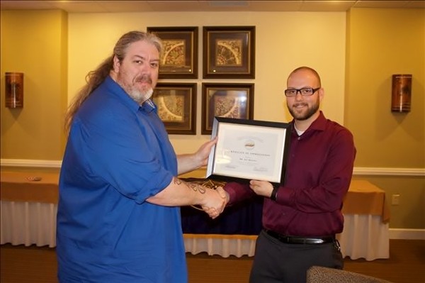 Guest speaker Lee Brandt (l) receives an award from Steven Dalton, vice president of Young AFCEAN affairs, at the March event.
