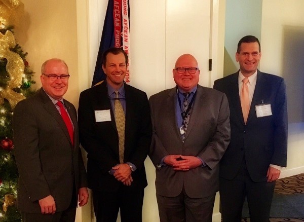 Welcoming AFCEA Chairman of the Board and Booz Allen Hamilton Executive Vice President Joe Sifer (2nd from r), guest speaker at the chapter's December general membership meeting, are (l-r) Chapter Chairman of the Board Brad Genet; Director at Large Rich Garner; and Chapter Vice Chairman of the Board Mark Thompson.