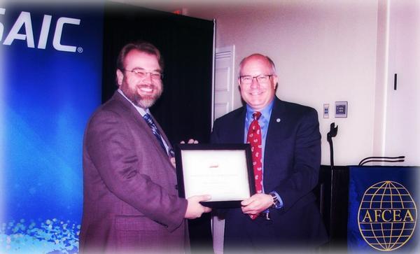 Coby Holloway, a vice president for Science Applications International Corporation (SAIC) (l), receives a guest speaker award from Chapter Chairman Brad Genet.