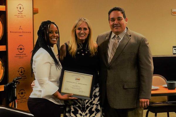 Chapter President Miguel Rivera (r) and Kathryn Thompson, chapter vice president, Women in AFCEA outreach (l), present a certificate to Sheri Donahue, president emeritus of InfraGard National Members Alliance, a participant in a May panel discussion about women in technology. Thompson was moderator.