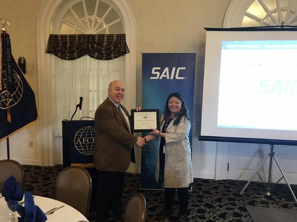 Chapter President Michael Tague presents Kuan Collins, solutions director, SAIC, with a certificate of appreciation at the March meeting.