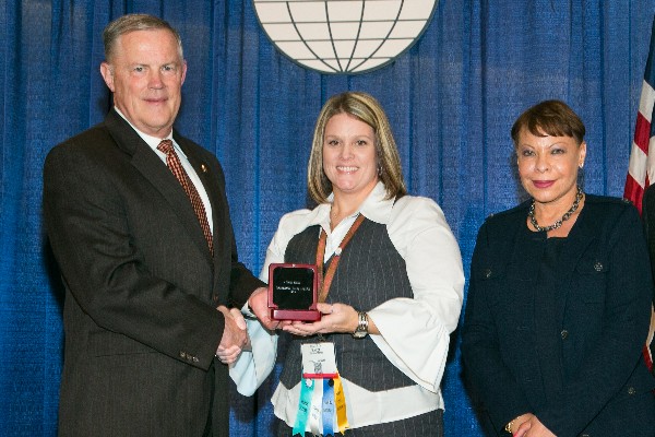 Lt. Gen. Robert M. Shea, USMC (Ret.), president and CEO, AFCEA International, and Linda Gooden (r), chair of AFCEA's board, present the Distinguished Young AFCEAN award to Mandi Septer in February.