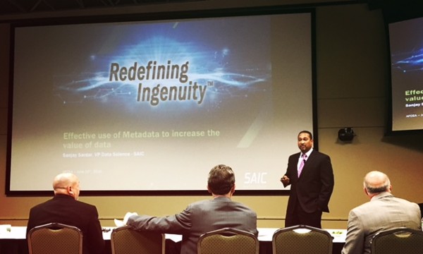 Sanjay Sardar, vice president for data science at SAIC, speaks at the June meeting.