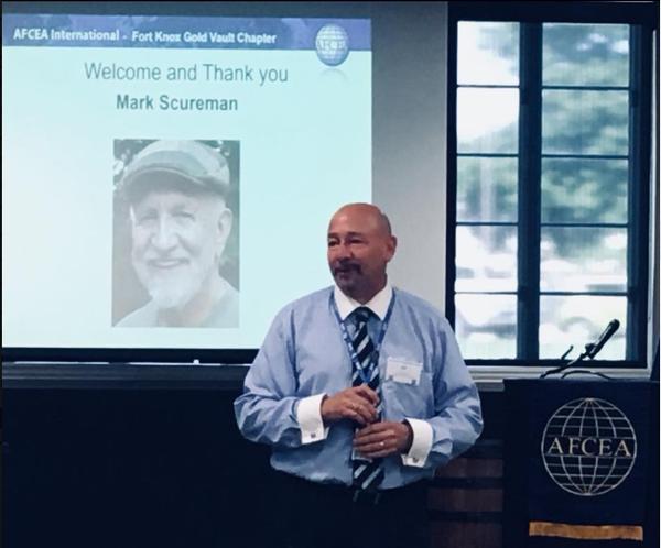 Martin Harbolt, chapter chairman of the board and regional vice president, explains in July that for each guest who joins AFCEA during a chapter event, a service member will receive a free membership. Photo: Angela Alexander-Mendoza