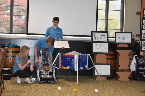 The robotics team displayed their robot and its abilities at the April event. Students also created finance plans and engineering CAD documents for the designs.