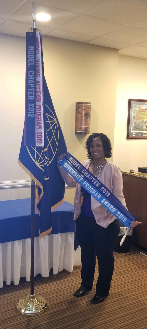 During the May event, Kathryn Thompson, chapter executive vice president and Women in AFCEA outreach leader, presents the chapter's award streamer for diversity.