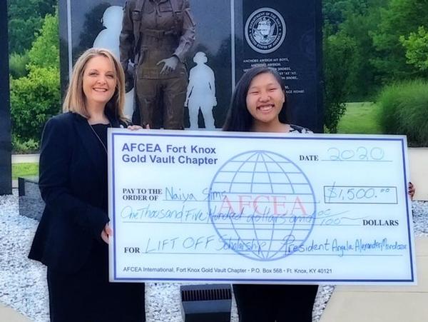 In July, Alexander-Mendoza presents Naiya Sims, biology major at Western Kentucky University, with a scholarship award.