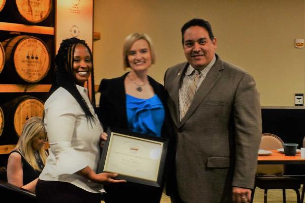 Brittany Robinson, a participant in the May panel (c), receives a certificate from Thompson (l) and Rivera.
