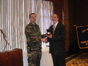 Chuck Strimpler (r), chapter president, presents Col. Thierry Belloeil, Acquisition Corps, French foreign liaison officer at Fort Monmouth, with a token of appreciation for serving as the March featured speaker.
