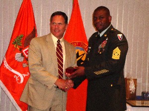 Skip Deitz (l), chapter first vice president, presents a token of thanks to Command Sgt. Maj. Tyrone Johnson, USA, who served as the keynote speaker in June.