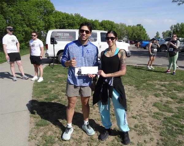 Pictured are the top male finisher at the May 5K, Noah Sanchez, Omaha, Nebraska - 1st Place, and Elizabeth Dennis, one of the chapter's prolific volunteers.