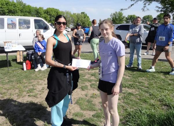 Pictured are the top female finisher at the May 5K, Temple Dugan, Papillion, Nebraska - 1st Place, and Dennis (left).